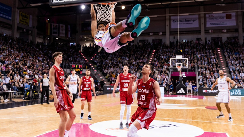 Vācijas valstsvienības 20 gadīgais aizsargs Džeks Kajils triec bumbu horvātu grozā. Foto: FIBA